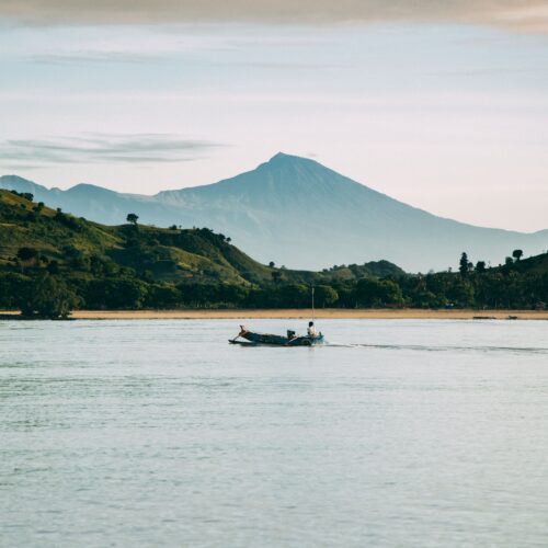 A serene boat ride with a stunning view of Mount Rinjani at West Nusa Tenggara, Indonesia.